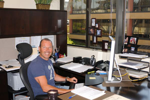 Photo of Phillipe Gallay at his desk