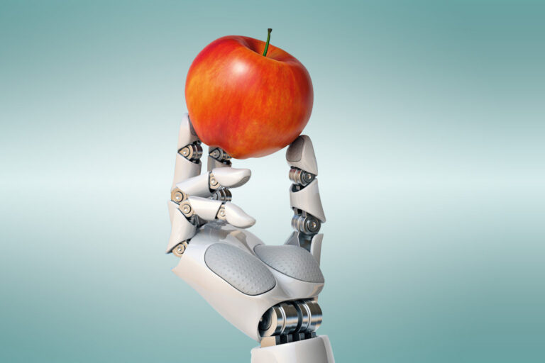 Robot hand holding a red apple.