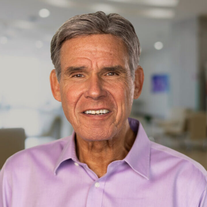 Professional headshot of Eric Topol, Scripps Research Executive Vice President and Founder of SRTI, in a light pink shirt with a modern office background.
