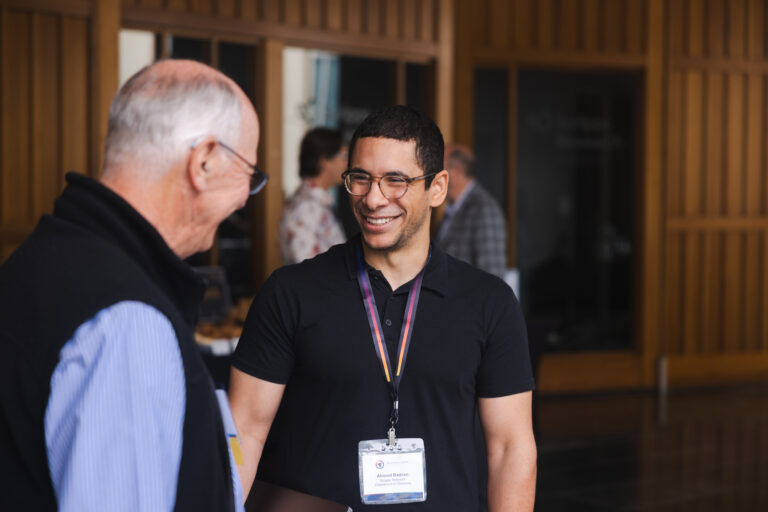 Two attendees networking and conversing at a Scripps Research technology development and innovation event.