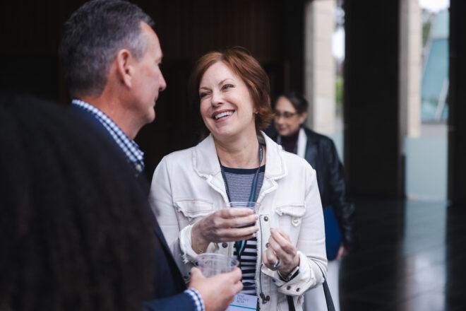Two Scripps Research supporters laughing and conversing at a donor event