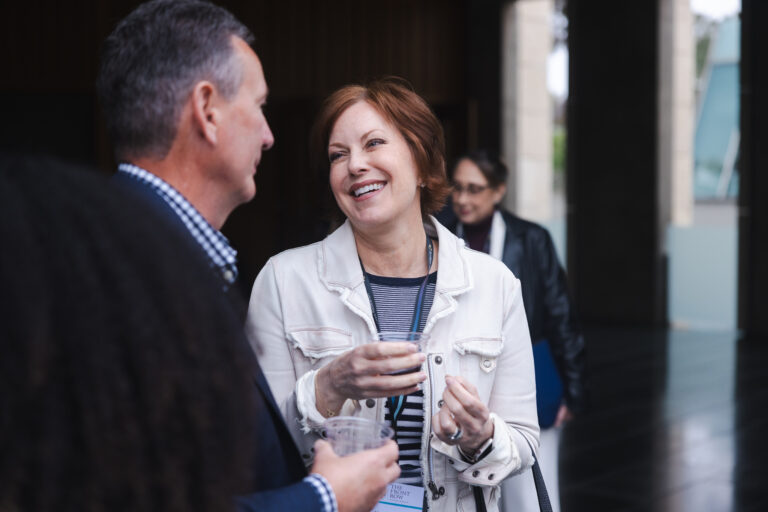 Two Scripps Research supporters laughing and conversing at a donor event