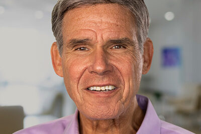 Professional headshot of Eric Topol, Scripps Research Translational Institute founder and director, in a light pink shirt.