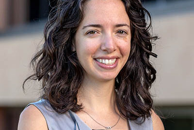 Professional headshot of Julia Moore Vogel, Scripps Research Translational Institute leader, outdoors in front of a building.