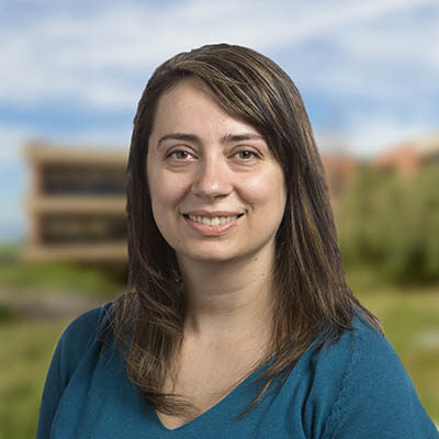 Professional headshot of Emily Spencer, Scripps Research Translational Institute staff member, outdoors with campus background.