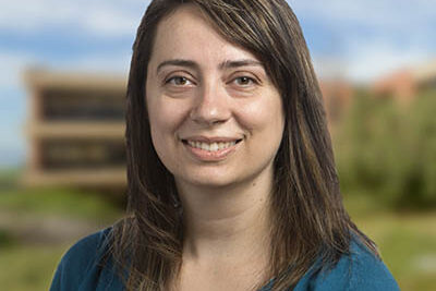 Professional headshot of Emily Spencer, Scripps Research Translational Institute staff member, outdoors with campus background.