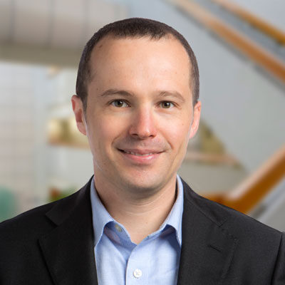 Professional headshot of Giorgio Quer, Scripps Research Translational Institute faculty member, in a dark blazer.