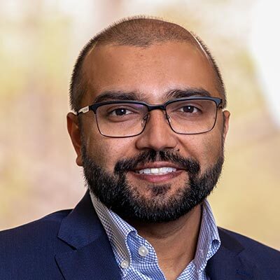 Professional headshot of Jay Pandit, Scripps Research faculty and SRTI Executive Committee member, wearing glasses and a dark blazer.
