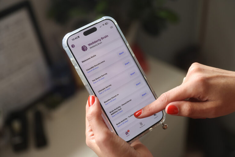 Smartphone with research app on screen.