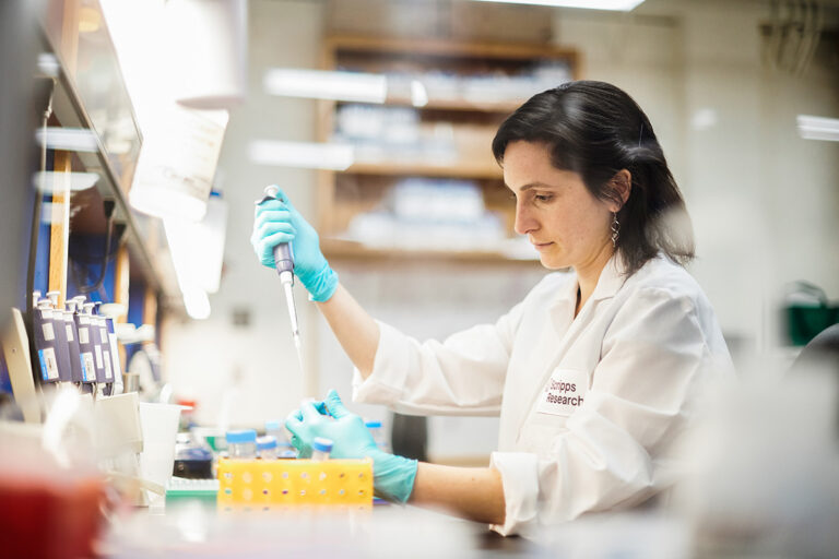 Scientist pipetting in a laboratory.