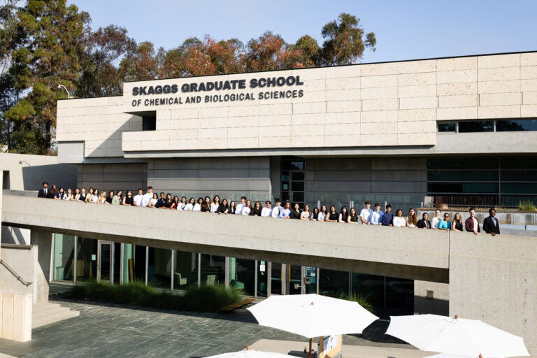 A group of interns lined up in front of the Skaggs Graduate School at Scripps Research.