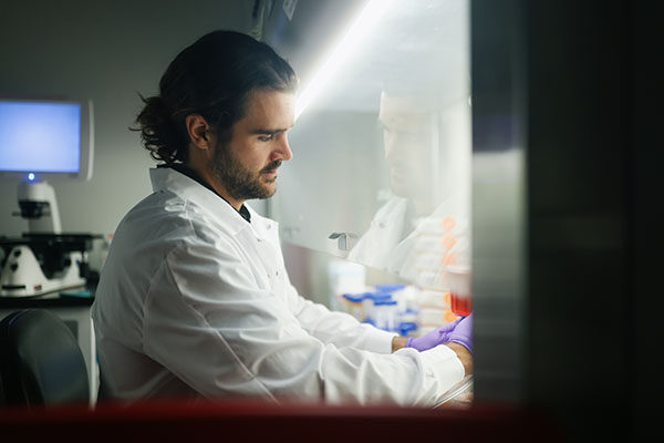 Calibr-Skaggs lab member at hood.